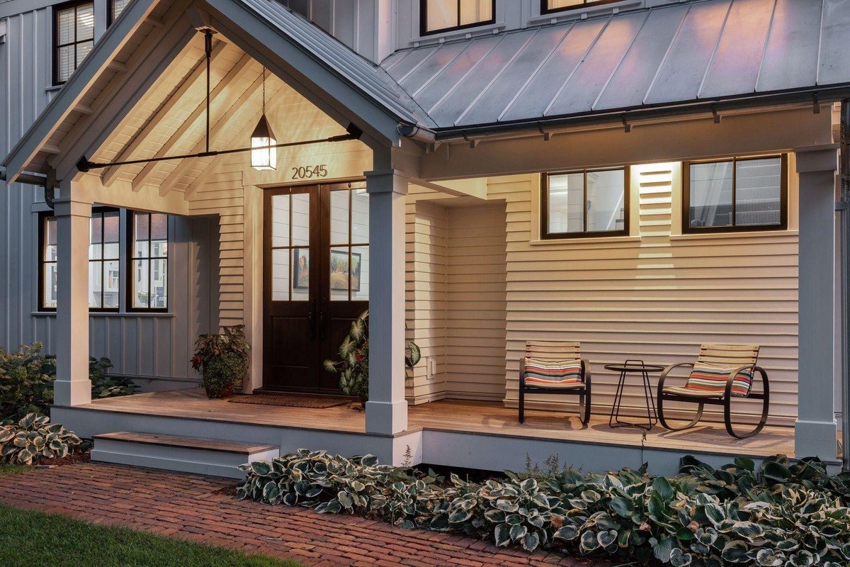 Front porch a welcoming entry with wooden double doors, porch seating, and warm lighting.