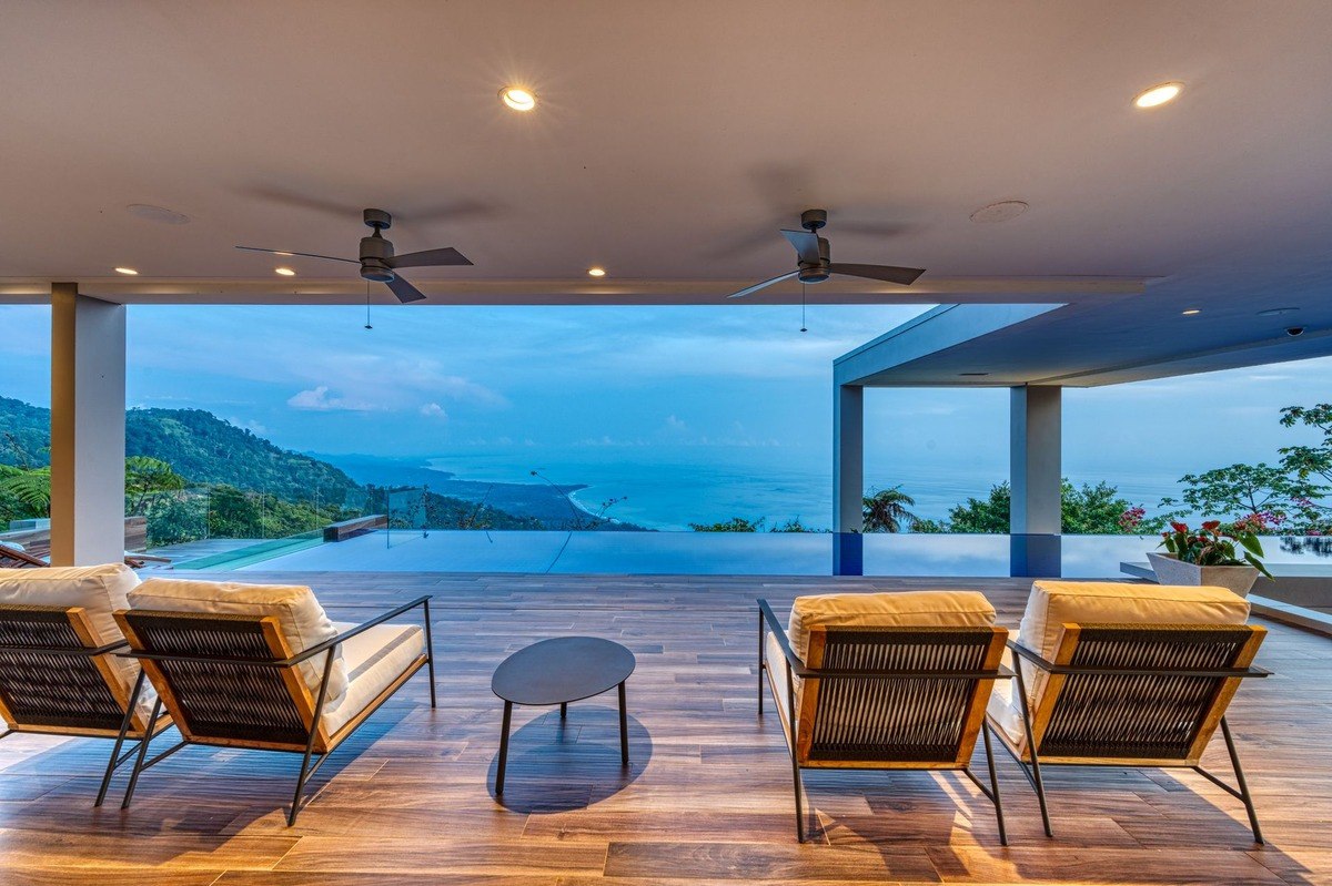 Oceanfront patio has infinity pool and lounge chairs.