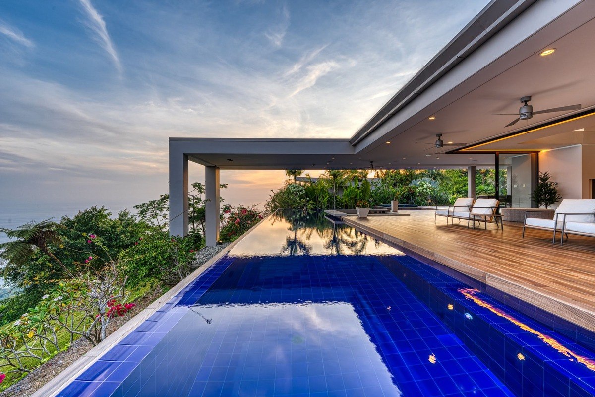 Infinity pool has ocean view and modern design.