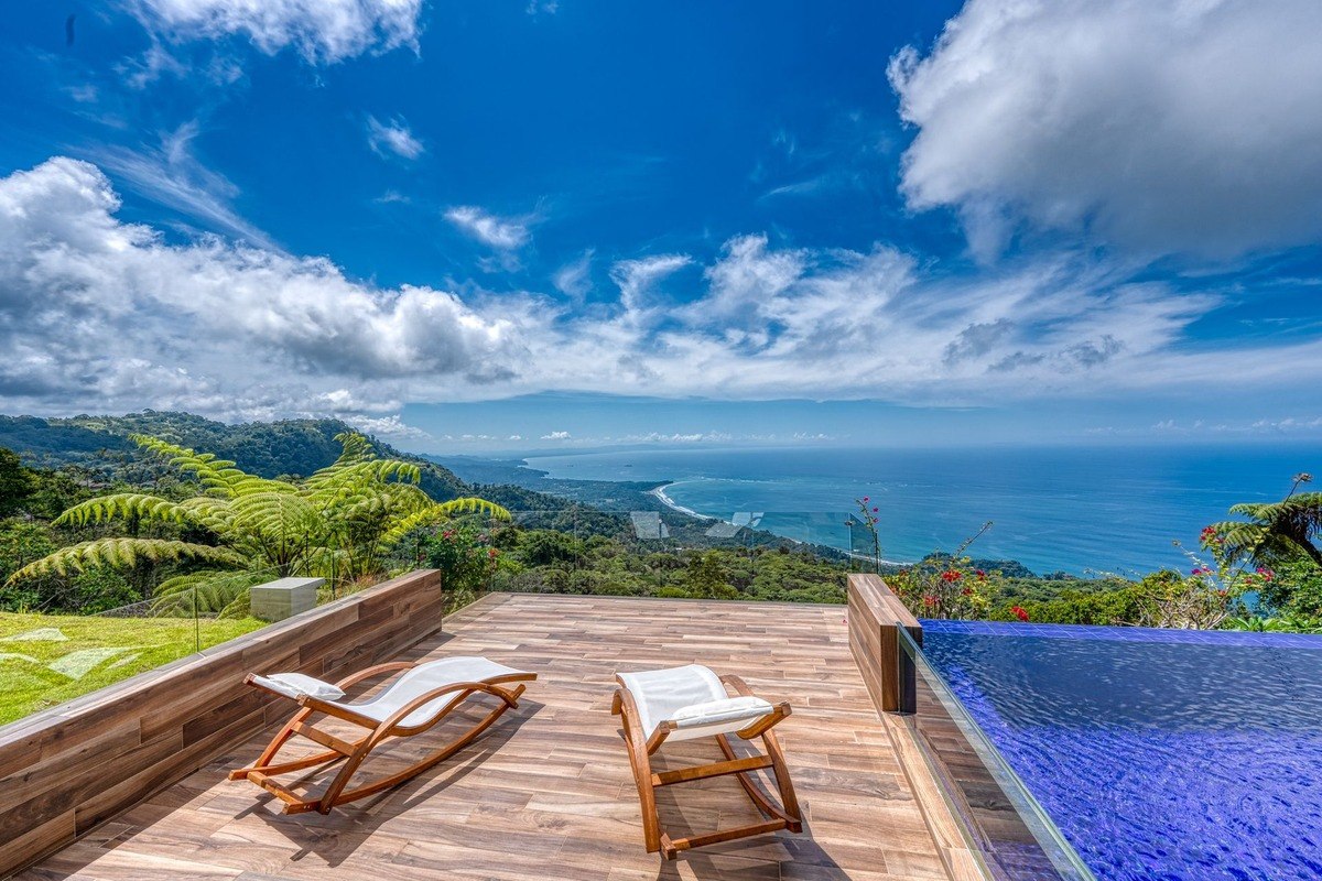 Ocean view deck has lounge chairs and infinity pool.