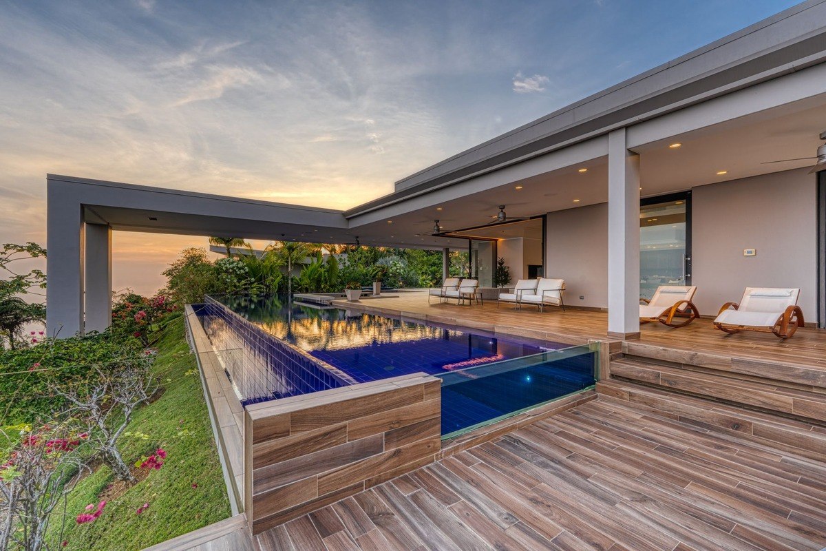 Infinity pool has ocean view and modern design.