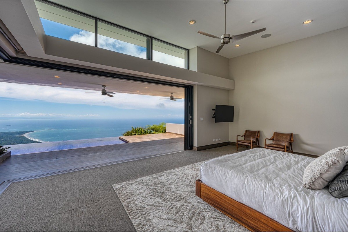 Master bedroom has ocean view and sliding glass doors.