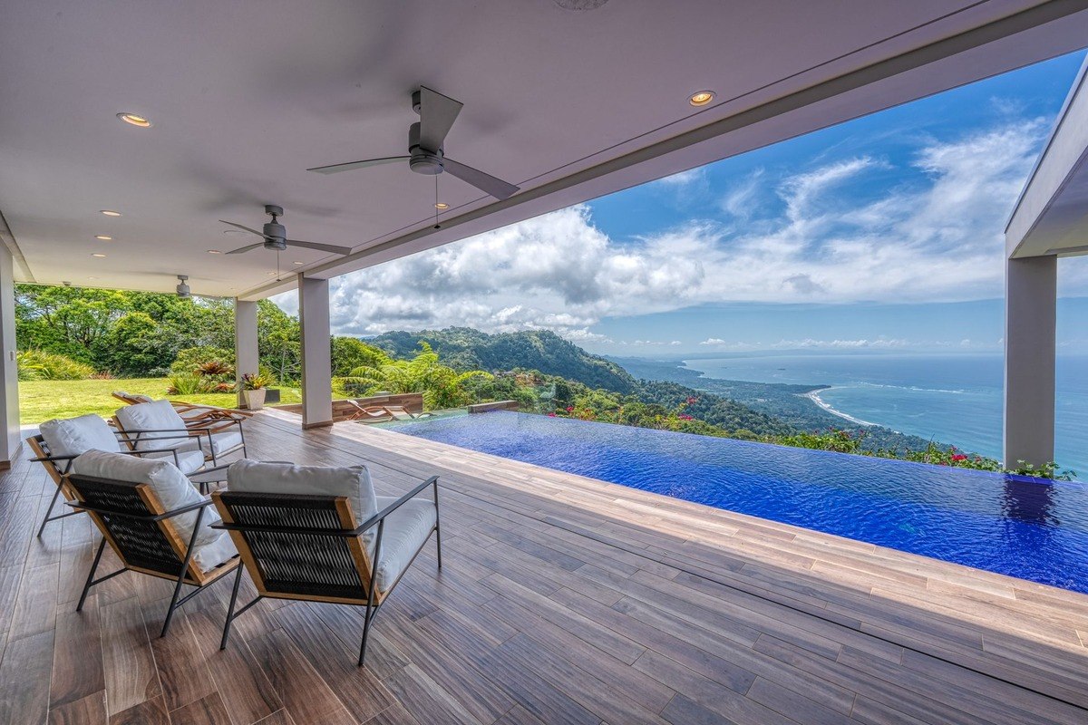 Ocean view patio has infinity pool and lounge chairs.