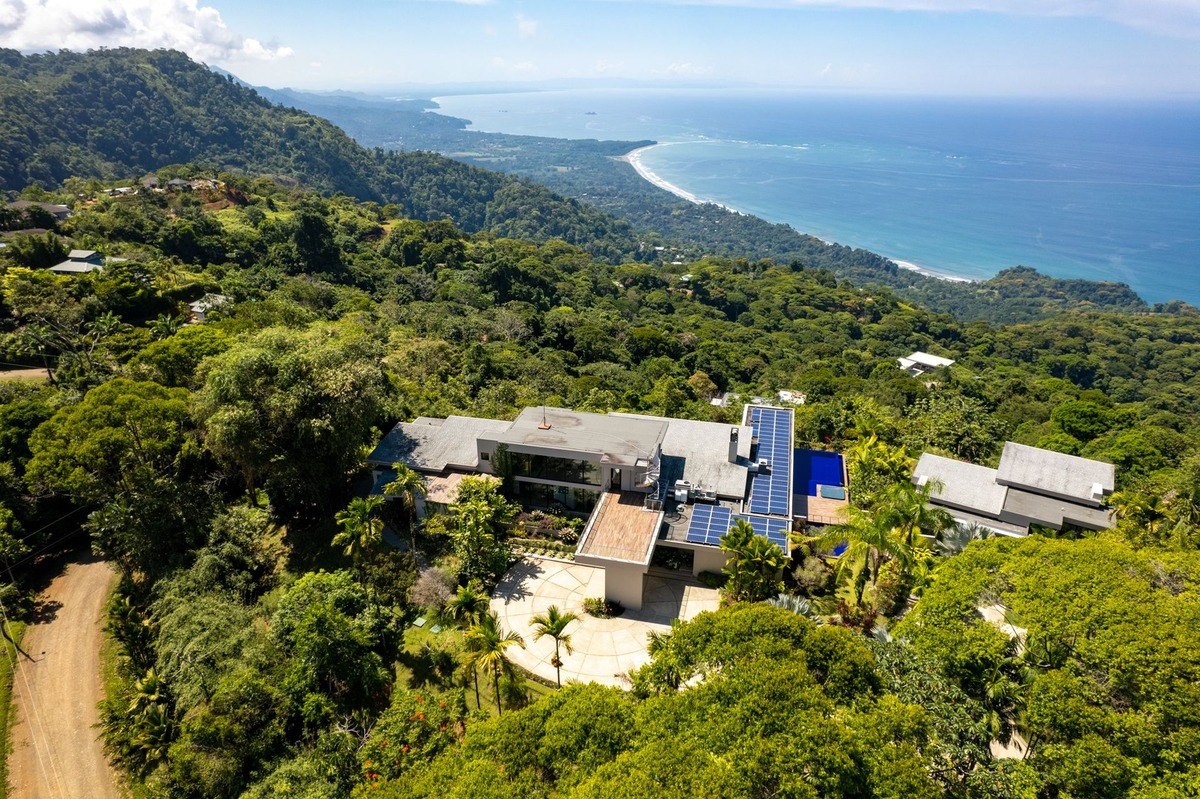 Hilltop home has ocean view and solar panels.