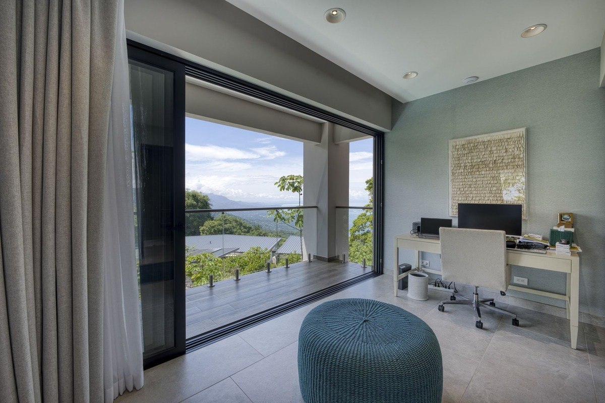 Office has desk, chair, and view of mountains.