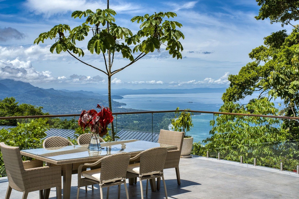 Patio has table and chairs with ocean view.