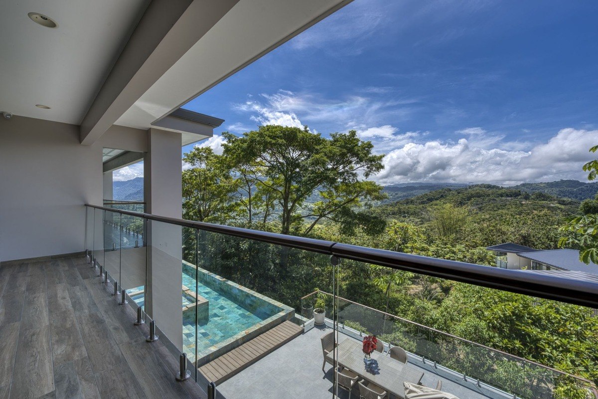 Balcony overlooks pool and mountain view.