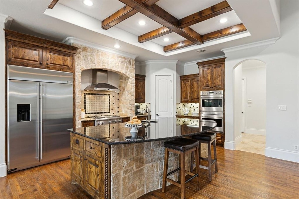 Breakfast nook with a wooden dining table, large windows, and a built-in display cabinet.