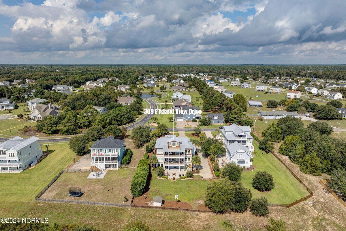 Aerial view shows house and surrounding neighborhood.