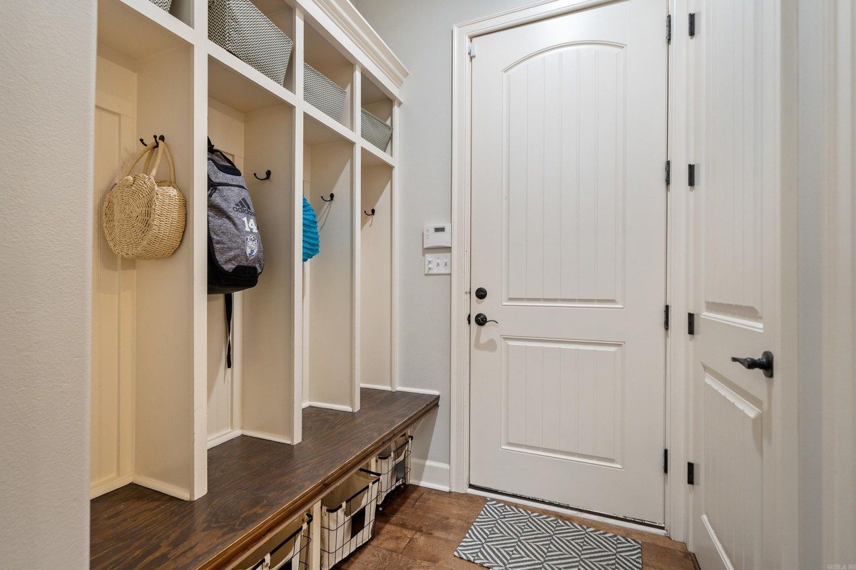 Entryway with built-in cubbies, seating, and storage baskets.