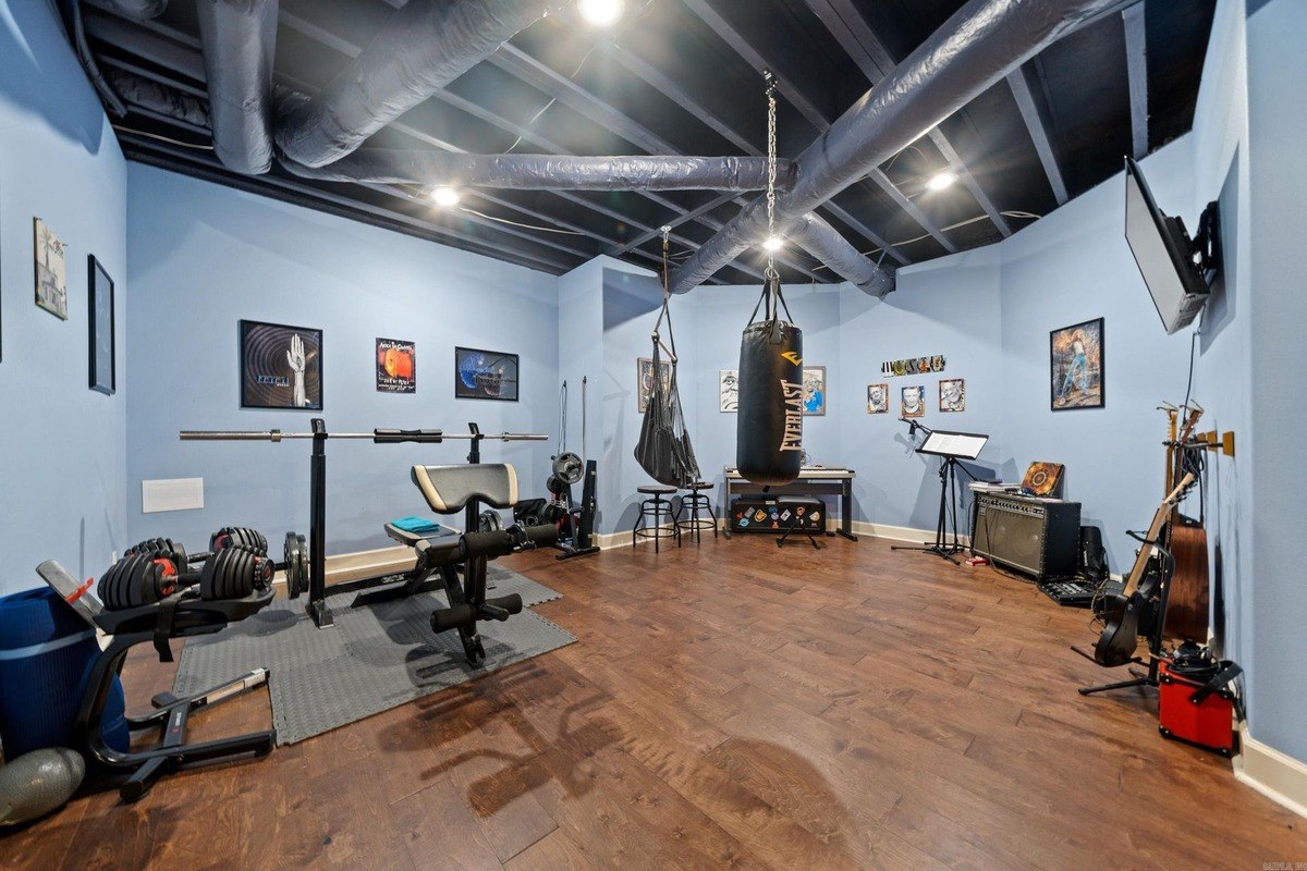 Basement workout and music room with weight equipment, a punching bag, and musical instruments.