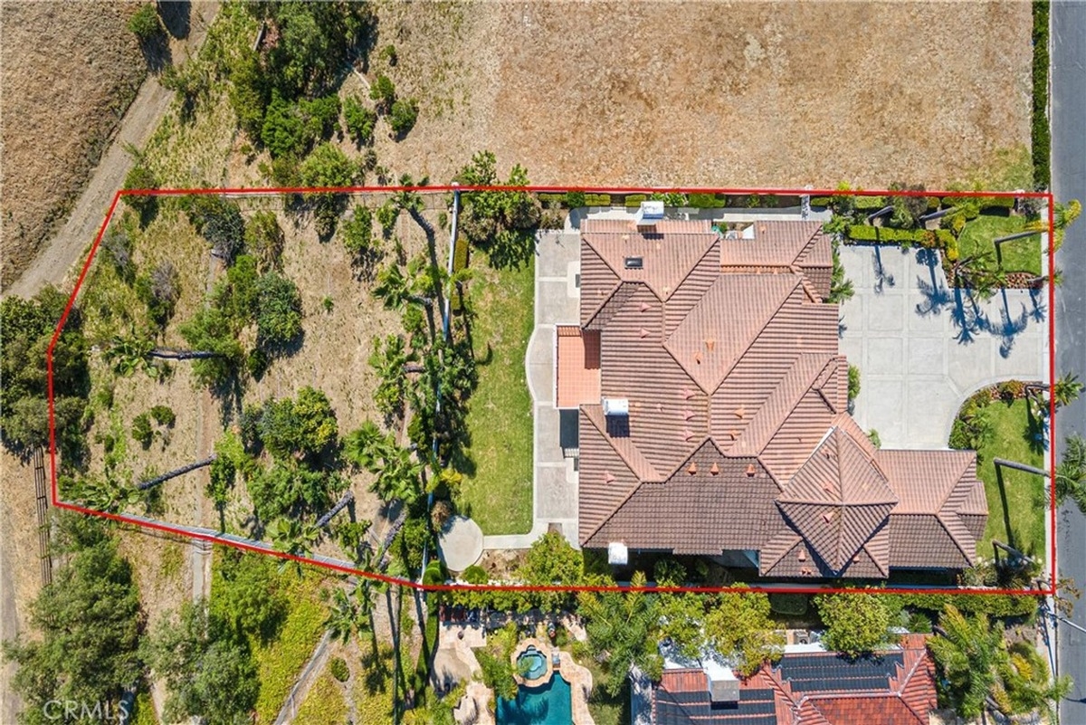 Aerial view of a large residential property with outlined boundaries, showing landscaping and spacious surroundings.