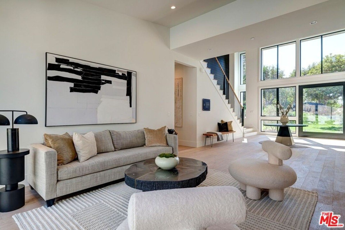 Cozy seating arrangement with a textured sofa and abstract artwork in a bright space.