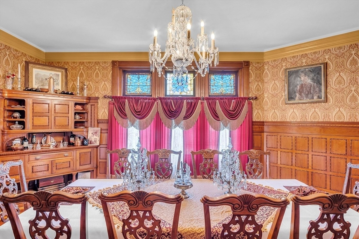 Kitchen is designed with rich wooden cabinets, granite countertops, tiled backsplash, and modern appliances.