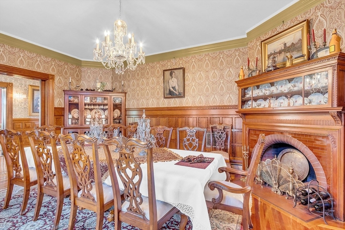 Adjacent kitchen space extends into a dining area with large windows and an open layout.