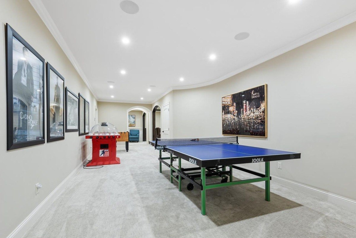 Game room entertainment room featuring a ping-pong table and bright recessed lighting.