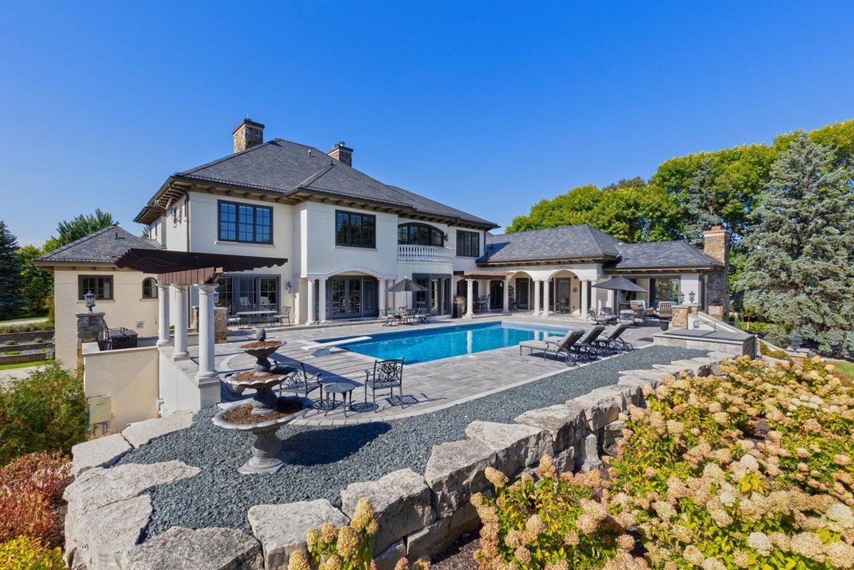 Backyard pool area expansive outdoor space with a pool, patio seating, and pergola.