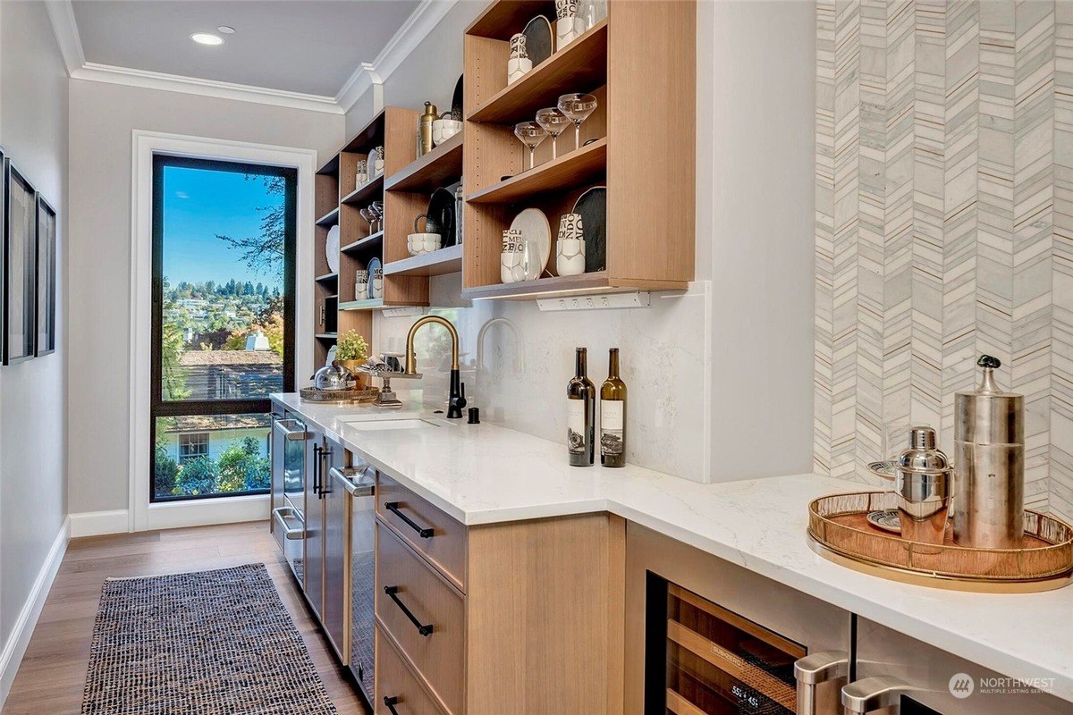 Wet bar has wood cabinets, white countertops, and herringbone tile backsplash.