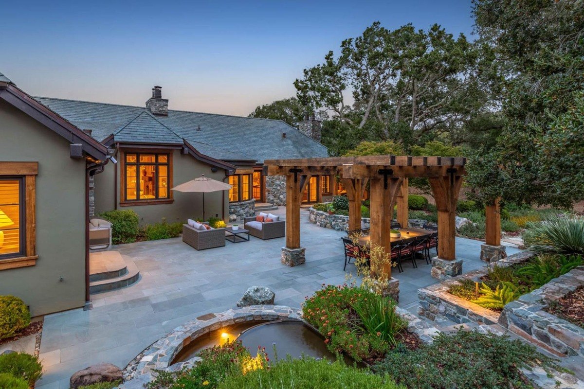 Outdoor patio view the patio area features comfortable seating, a pergola, and landscaping.