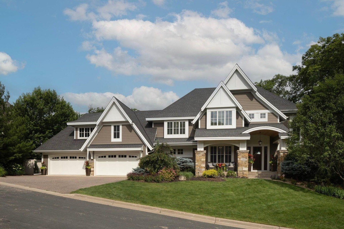 Two-story home with a three-car garage and landscaped front yard.