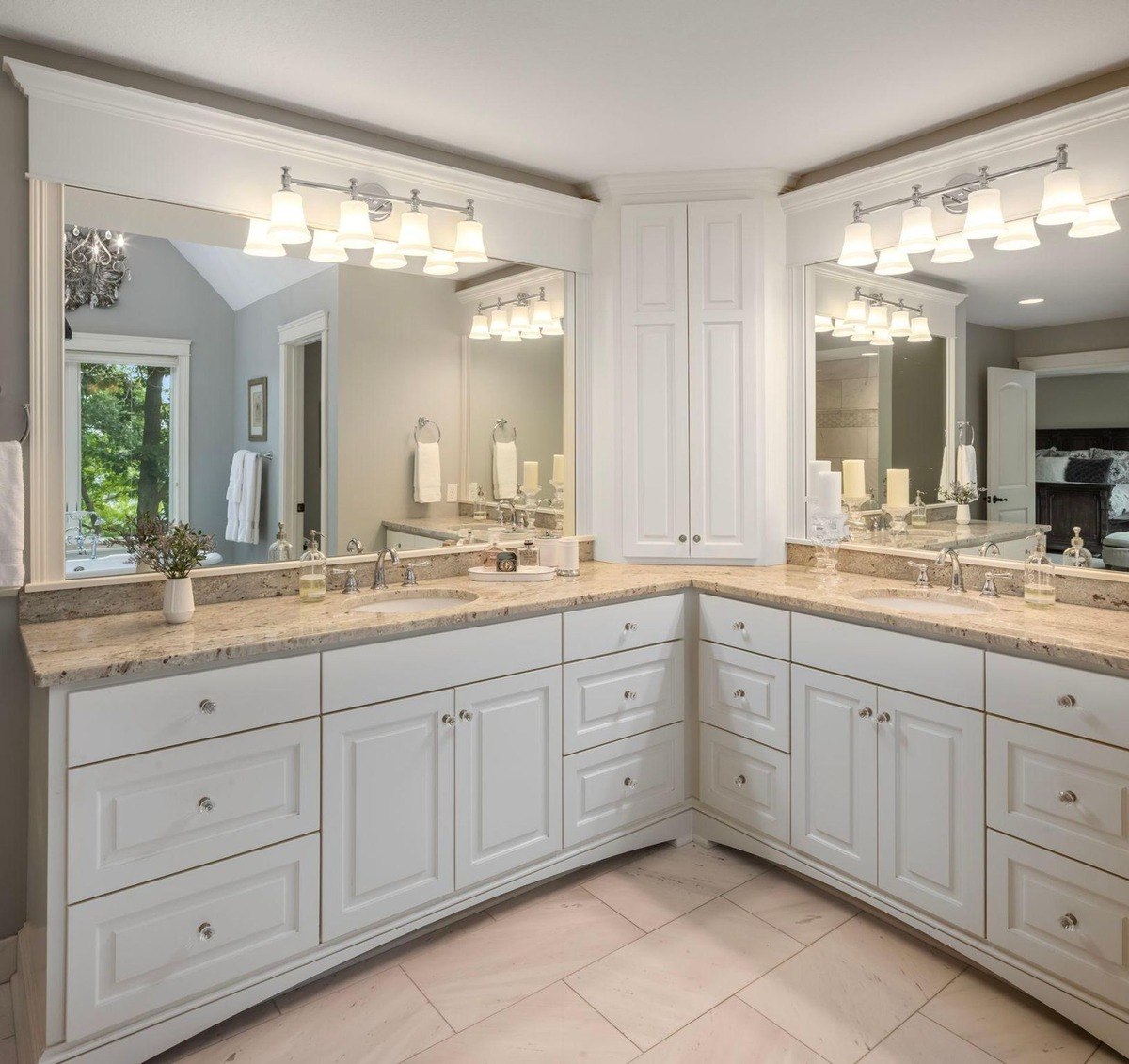 Bathroom with a double vanity, granite countertops, and a large mirror.