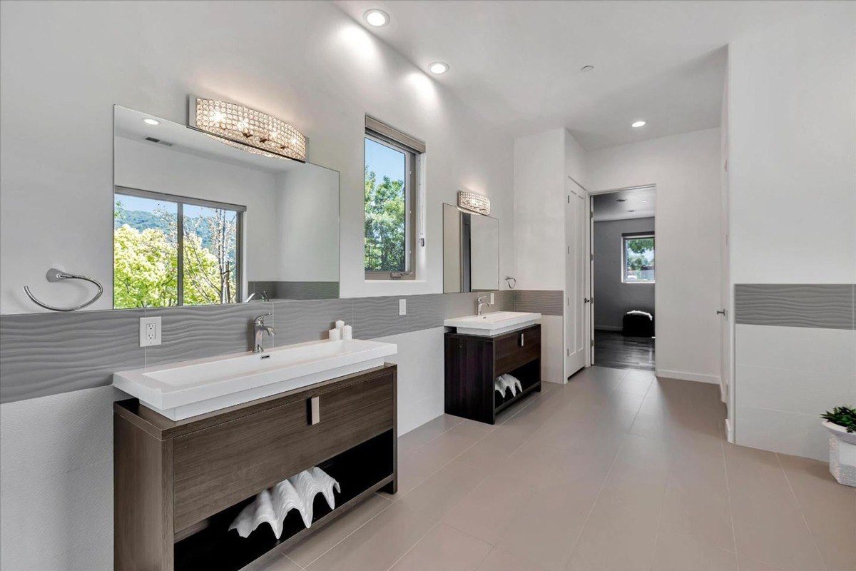 Double vanity bathroom a bathroom with dual sinks, large mirrors, and contemporary lighting.