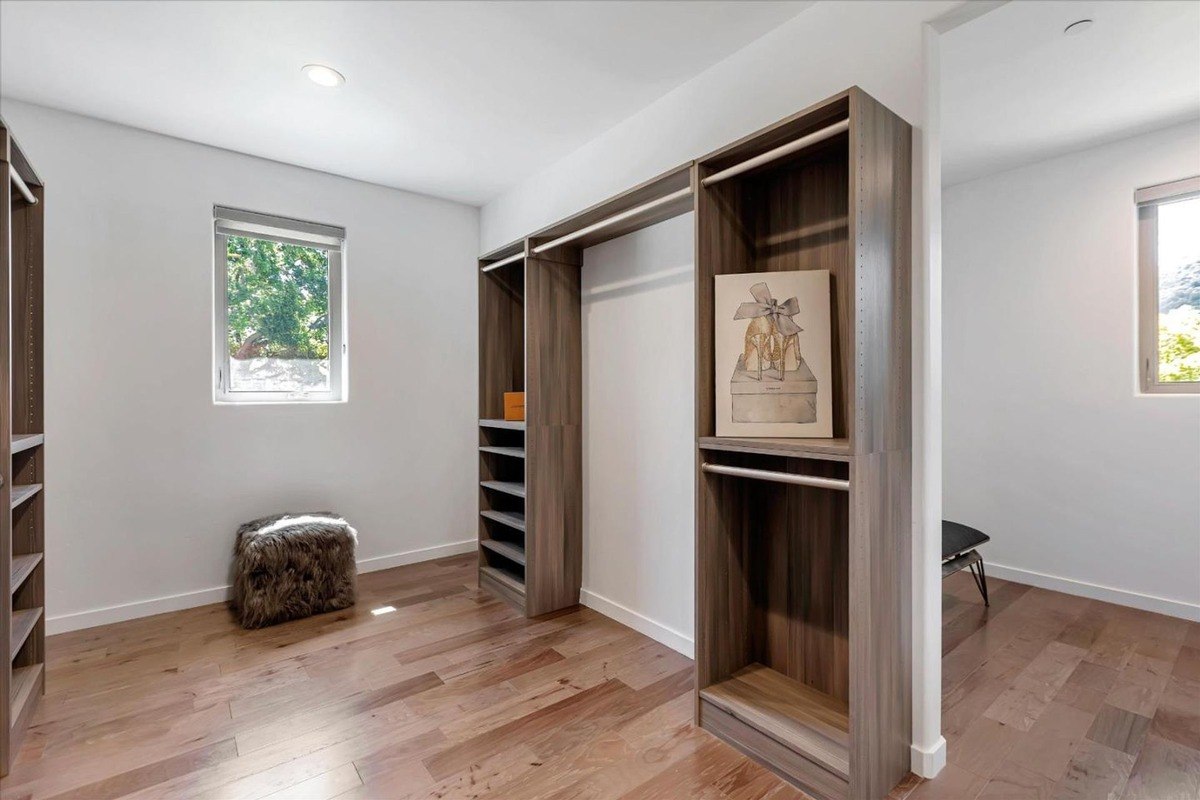 Walk-in closet a walk-in closet with open shelving and natural light from a window.