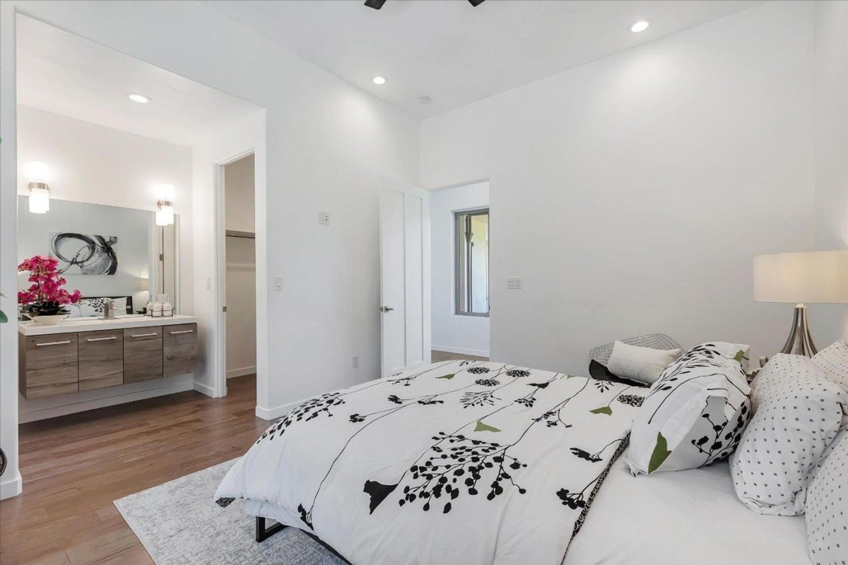 Ensuite bedroom a bedroom with ensuite access, white walls, and modern accents.