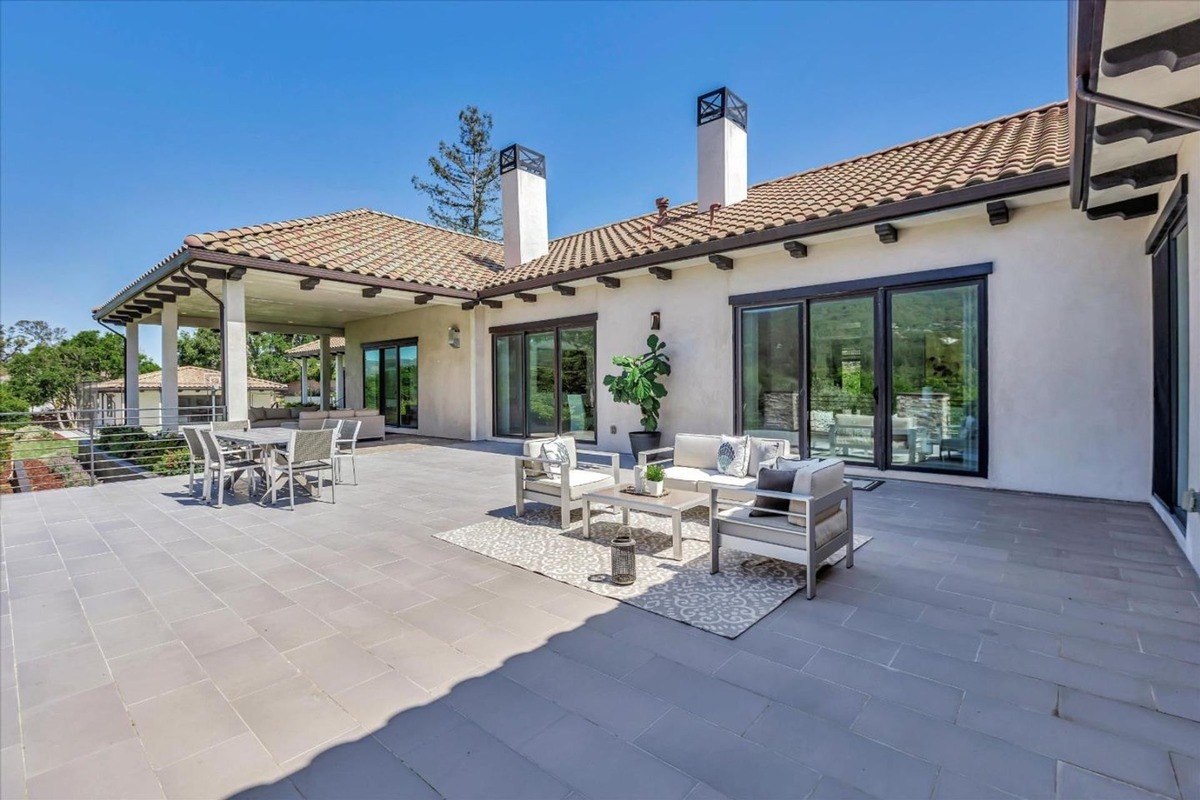 Expansive outdoor patio with seating areas and mountain views.