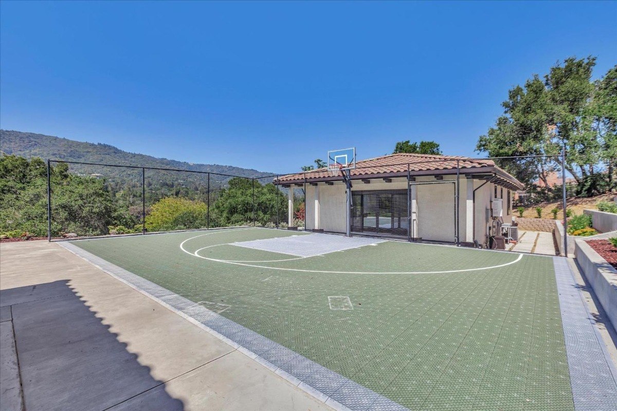 Private basketball court adjacent to a multi-use space or guest house.