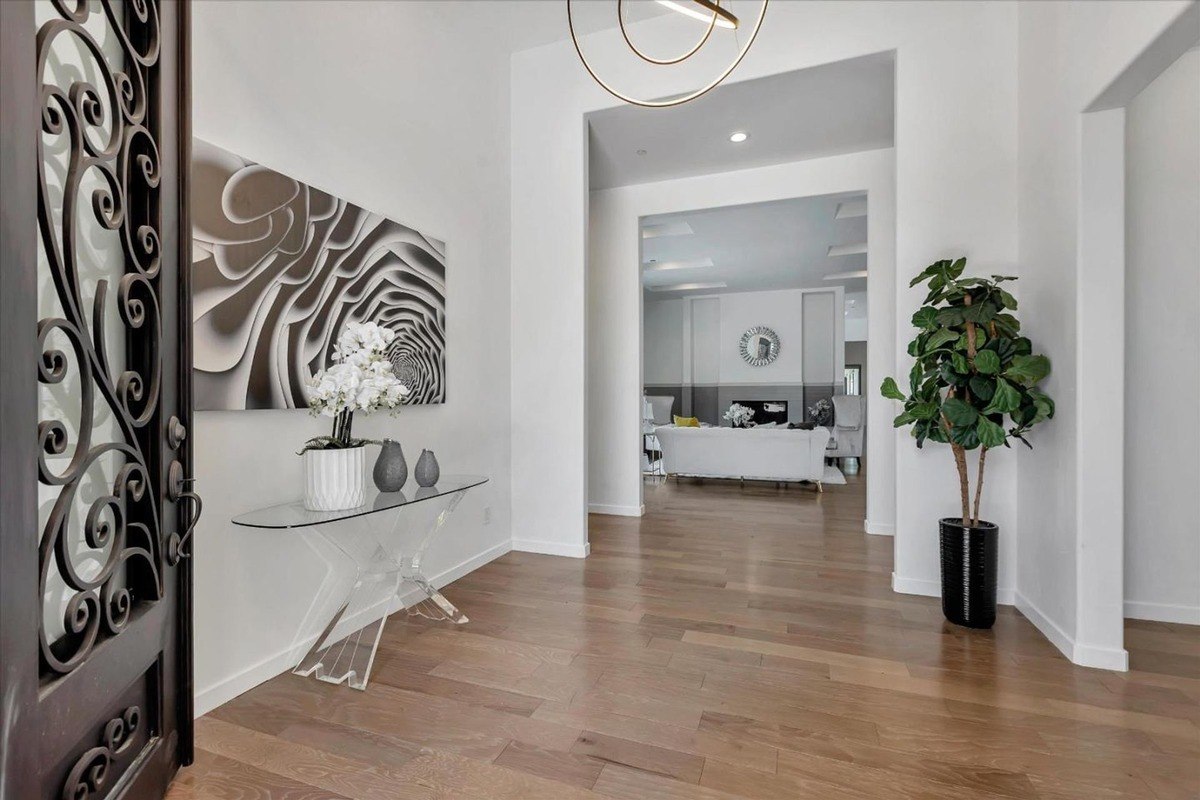 Entryway featuring a glass console table and modern decor.