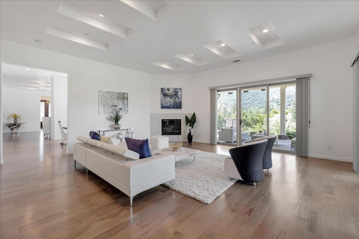 Family room with a seating area, fireplace, and sliding glass doors leading outside.