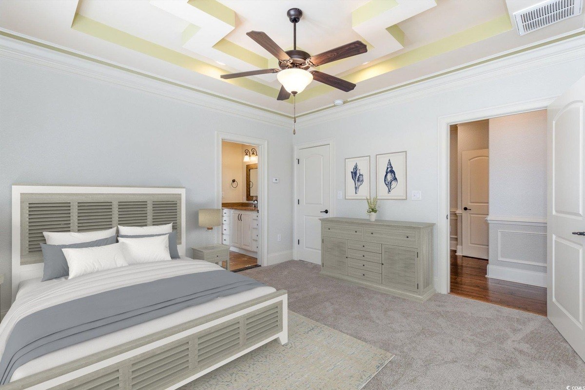 Bedroom has carpeting, a bed, and a ceiling fan.