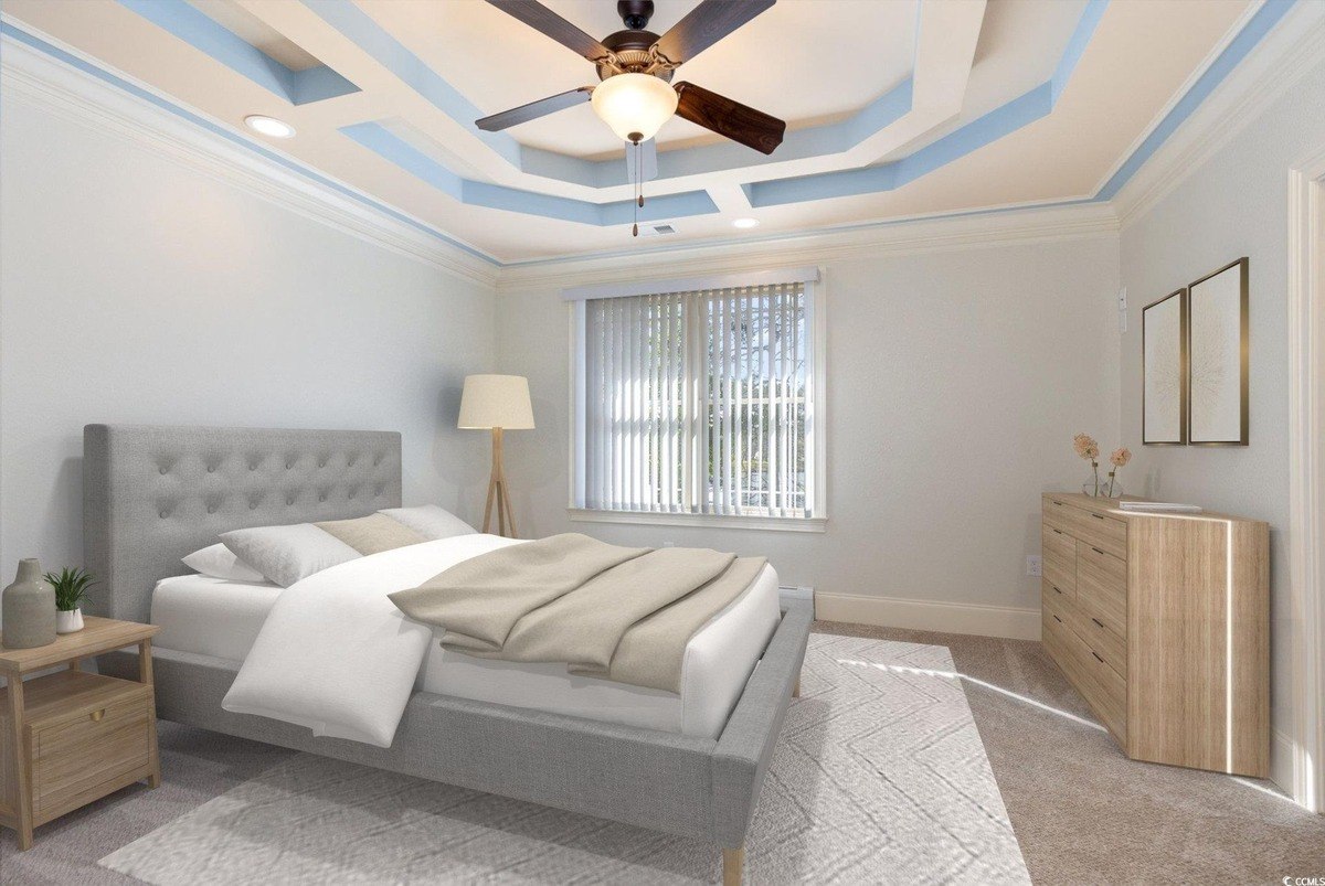 Bedroom has carpeting, a bed, and a ceiling fan with a unique design.