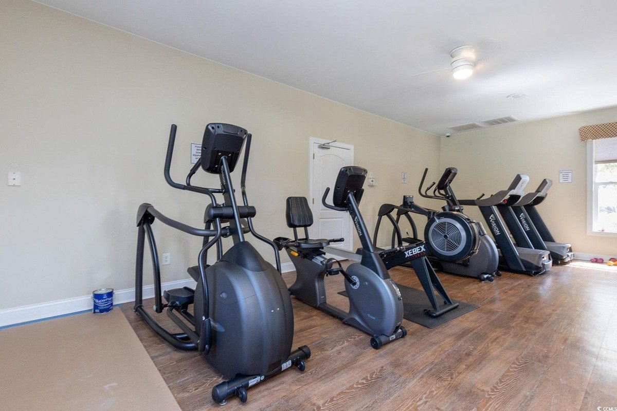 Small gym has elliptical machines, stationary bikes, and treadmills.