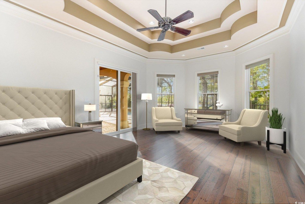 Master bedroom has hardwood floors, a bed, and access to a pool.