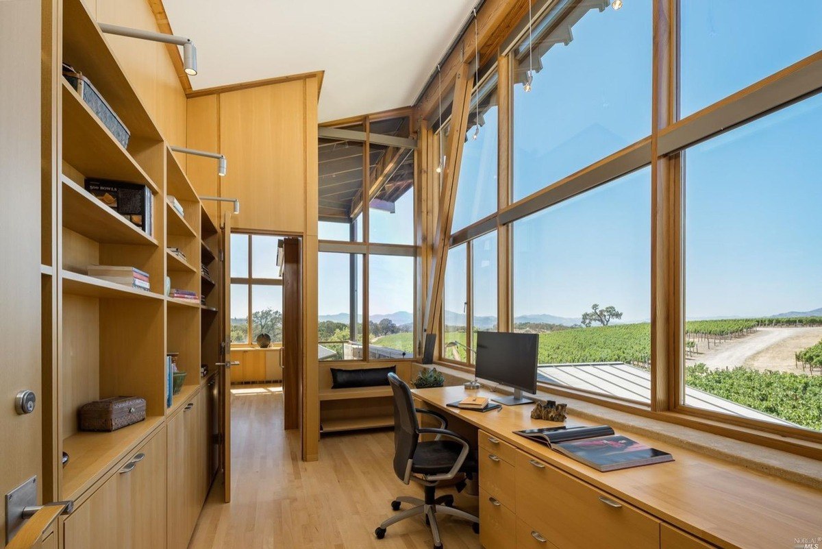 Study area features a desk with a large window offering vineyard views and ample natural light.