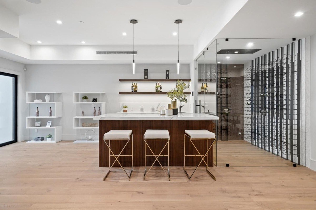 Bar area a modern home bar with wooden cabinets, floating shelves, and sleek pendant lighting.