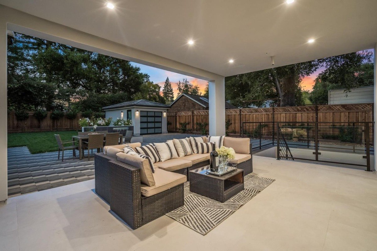 Covered patio an outdoor seating area with a sectional sofa and views of the backyard.