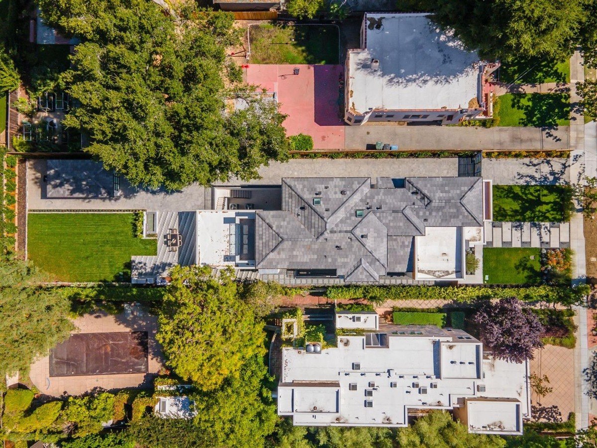 Aerial view a top-down view of the property showing the house, yard, and surrounding area.