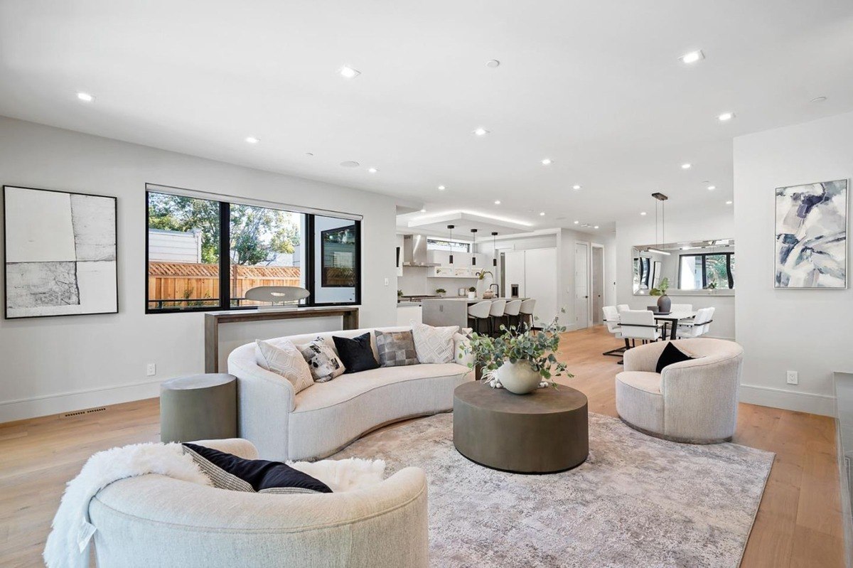 Spacious living and dining area an open floor plan with a seating area, dining space, and large windows bringing in natural light.