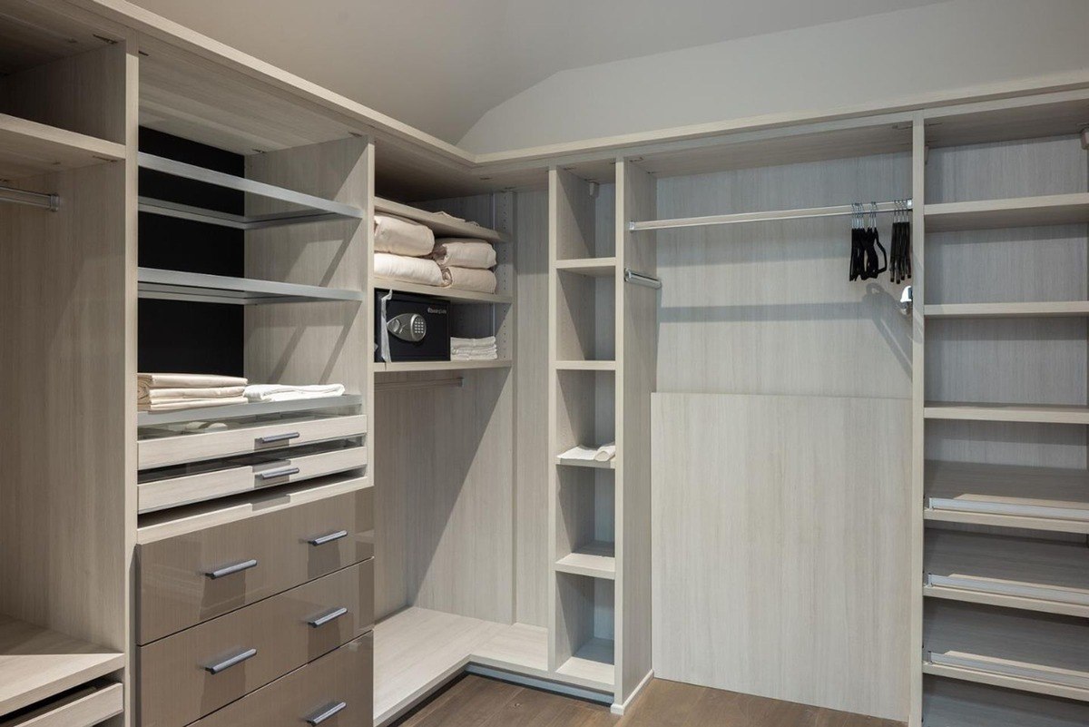 Walk-in closet with ample storage space, including shelves, drawers, and hanging rods.