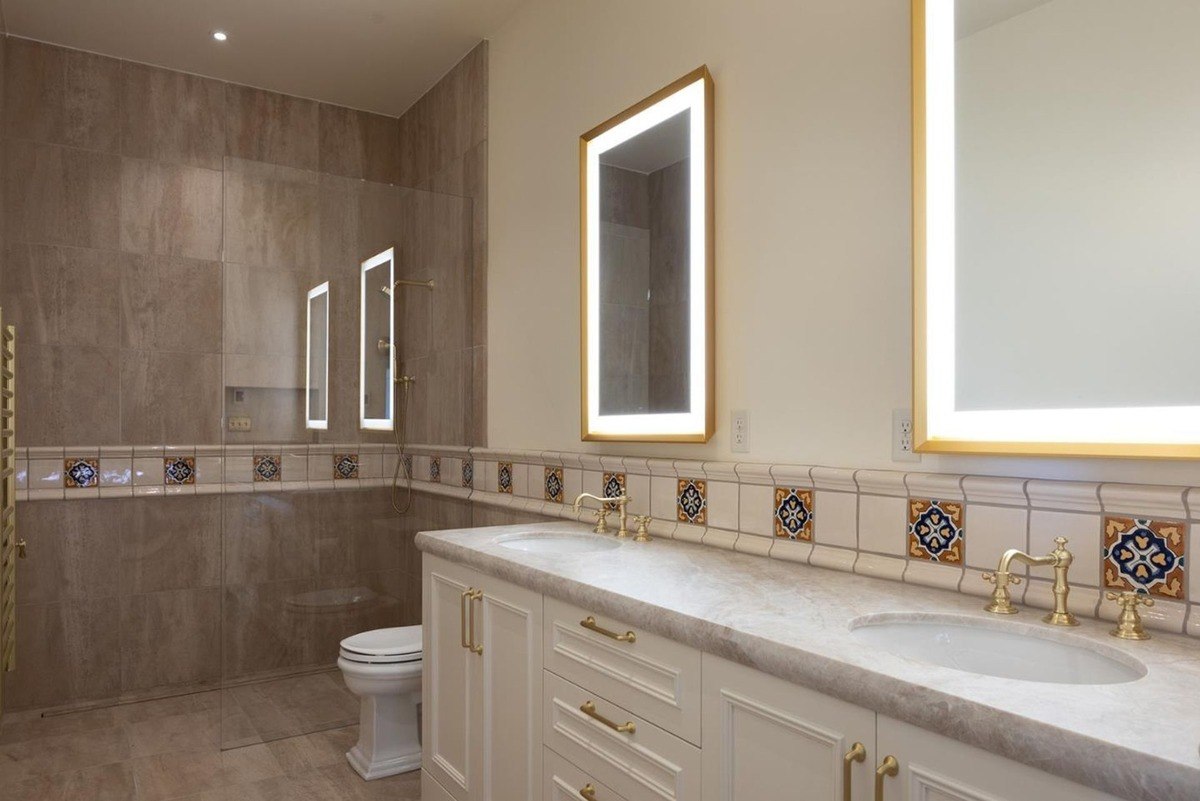 Bathroom with a double vanity, a walk-in shower, and a vintage-inspired design with decorative tile work.