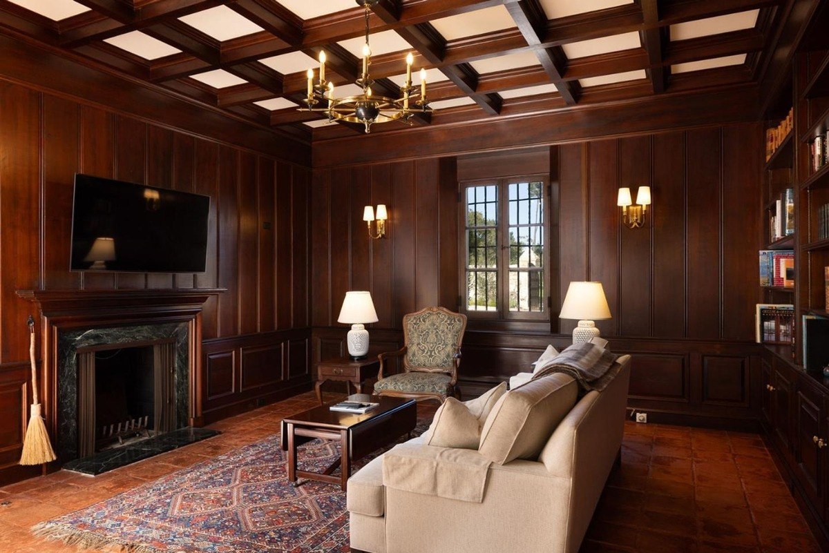 Bright living room boasts large windows and a grand piano, creating an elegant space infused with natural light.