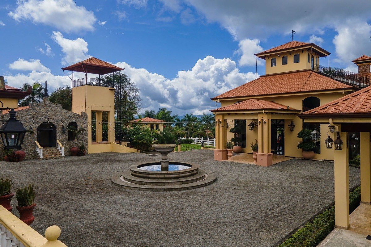 Courtyard has fountain and multiple buildings.