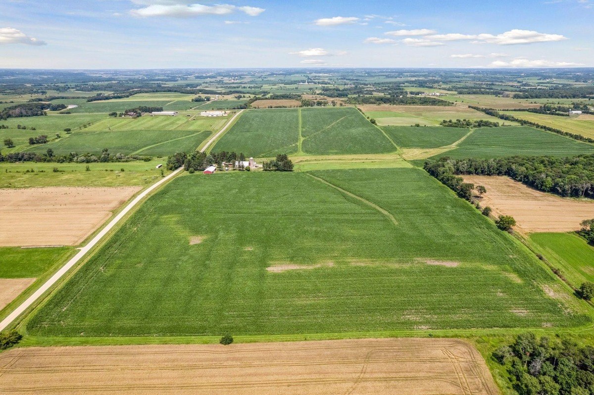 Aerial view of vast agricultural fields and surrounding rural landscapes.