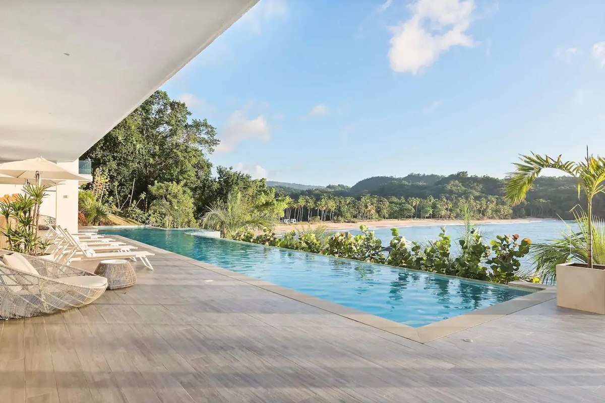 Infinity pool has lounge chairs and ocean view.