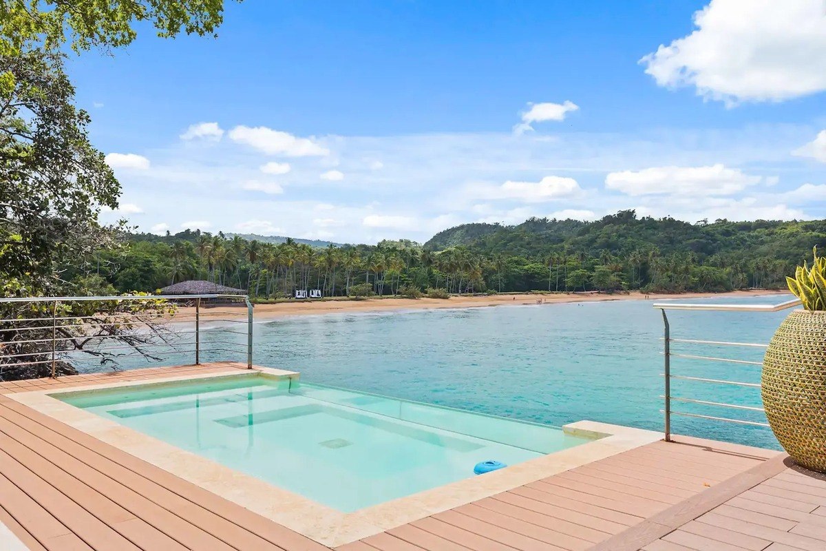 Oceanfront deck has small pool and beach view.