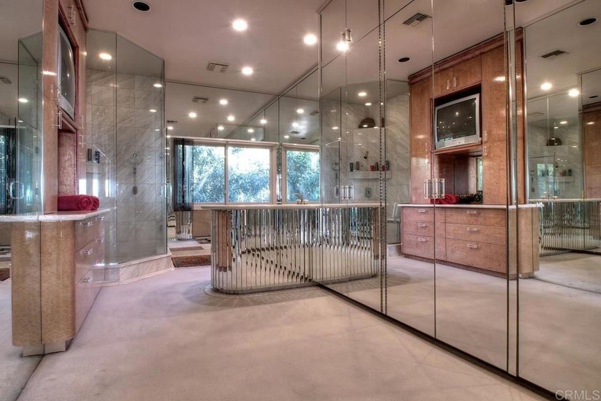 Living area with a sectional couch, a coffered ceiling, and seamless connection to the open kitchen space.