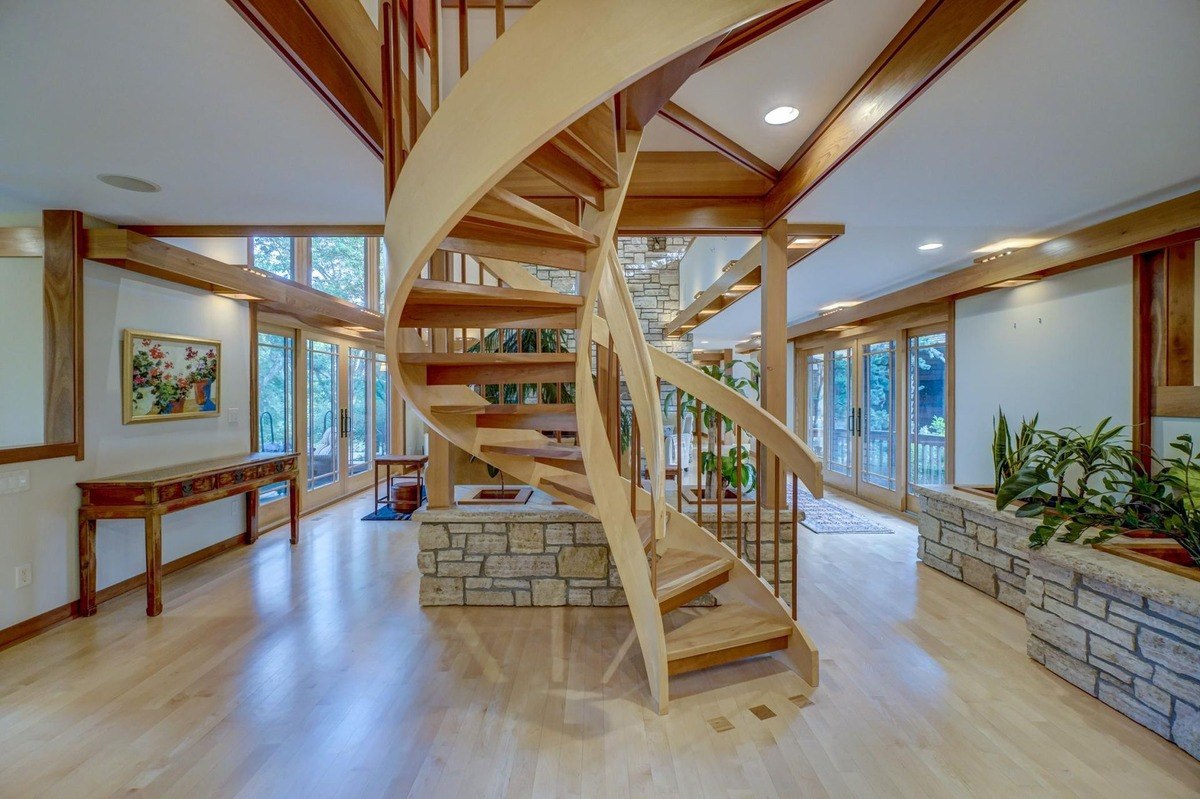 Graceful spiral staircase winds its way upward, adding a touch of elegance and visual interest to this spacious interior.